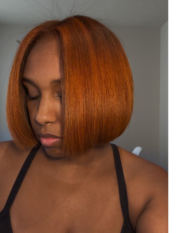 Guest with a sleek, chin-length blunt bob in a copper tone